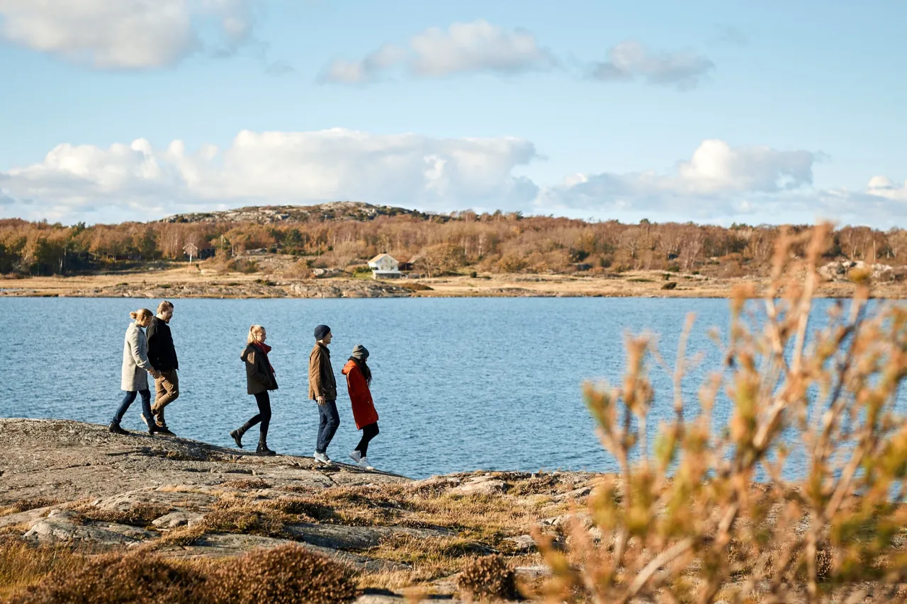 people walking along the sea