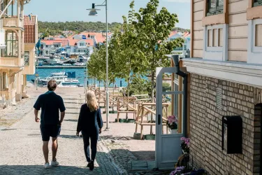 par promenerar på kullerstensväg, kustmiljö